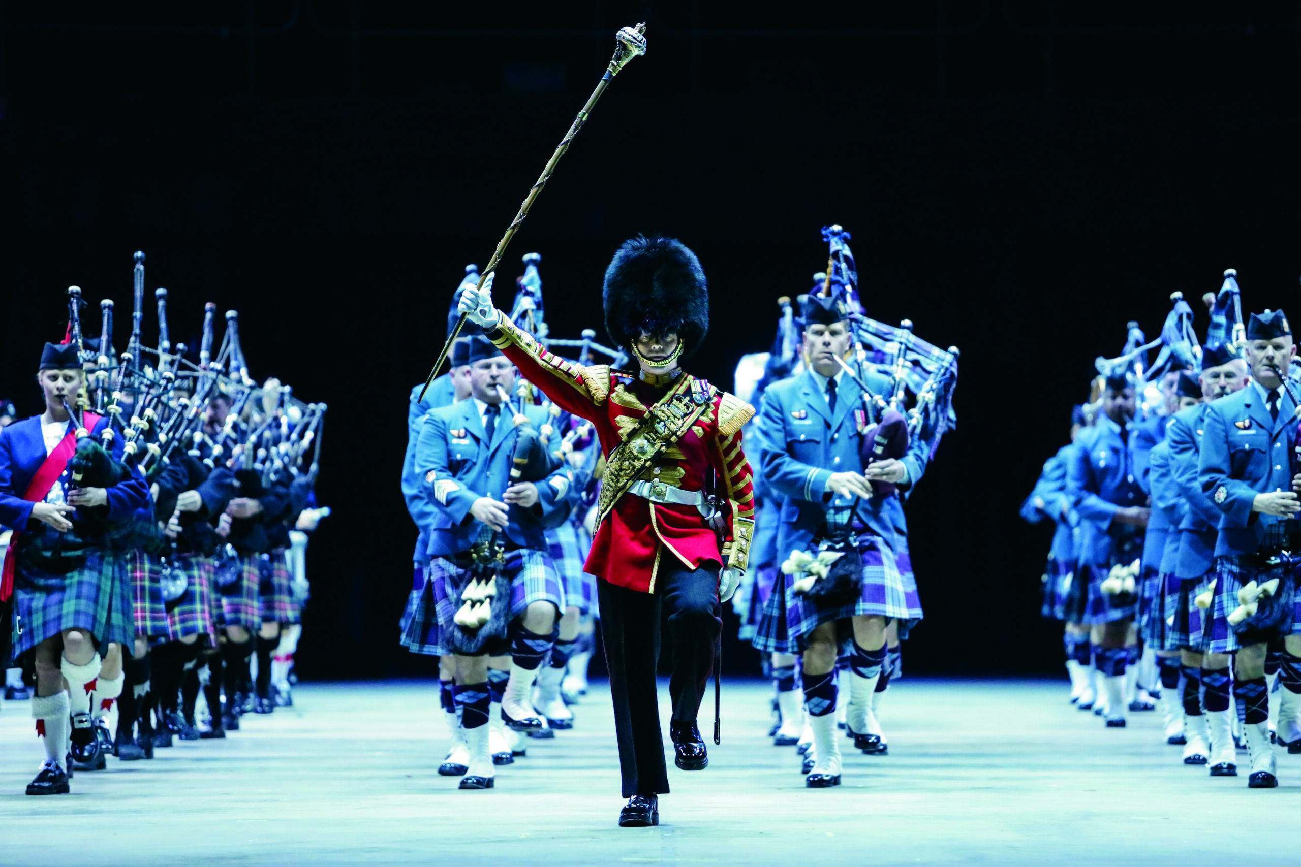 Men dressed in British Guard attire and Kilts playing bagpipes