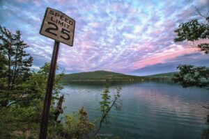 speed limit sign and sunset over lake