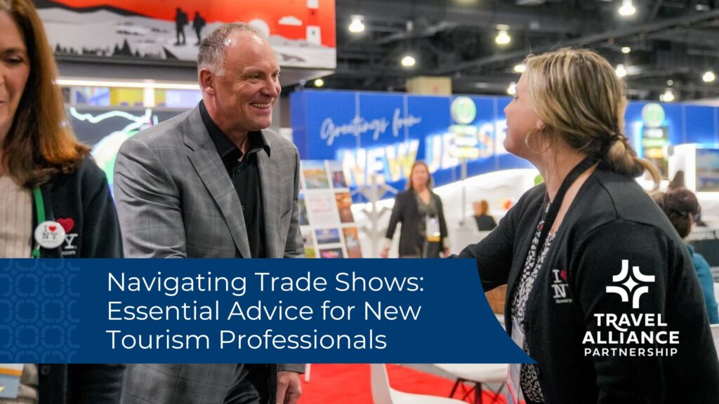 A man and woman smiling and shaking hands at a trade show. A blue banner overlaid on the image displays the blog title "Navigating Trade Shows: Essential Advice for New Tourism Professionals"