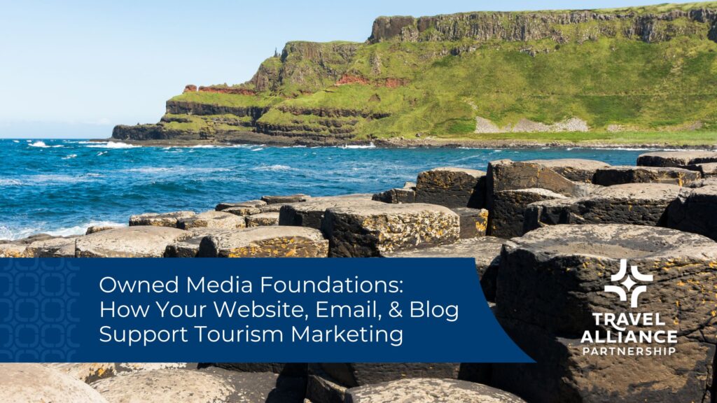 grassy cliffs in the background with blue water in the middle and rocks in the foreground. A blue banner shows the blog title Owned Media Foundations: How your website, email & blog support tourism marketing